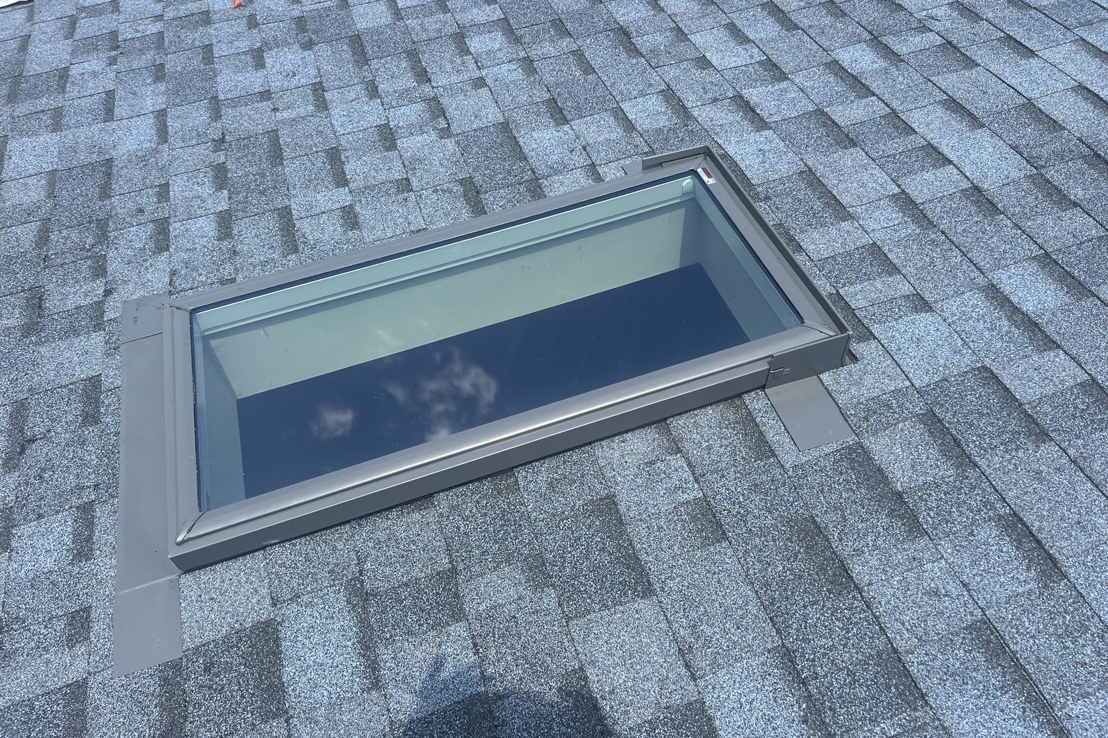 Completed skylight installation with new flashing and shingles on a New Jersey home