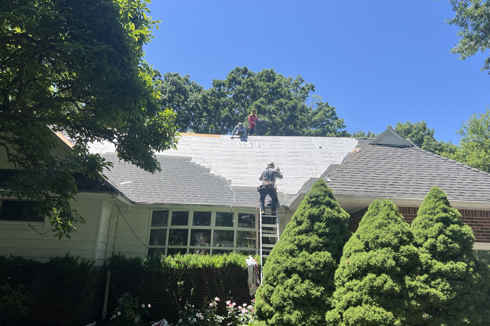 Ambassadors Construction roofing crew installing new underlayment on a New Jersey home