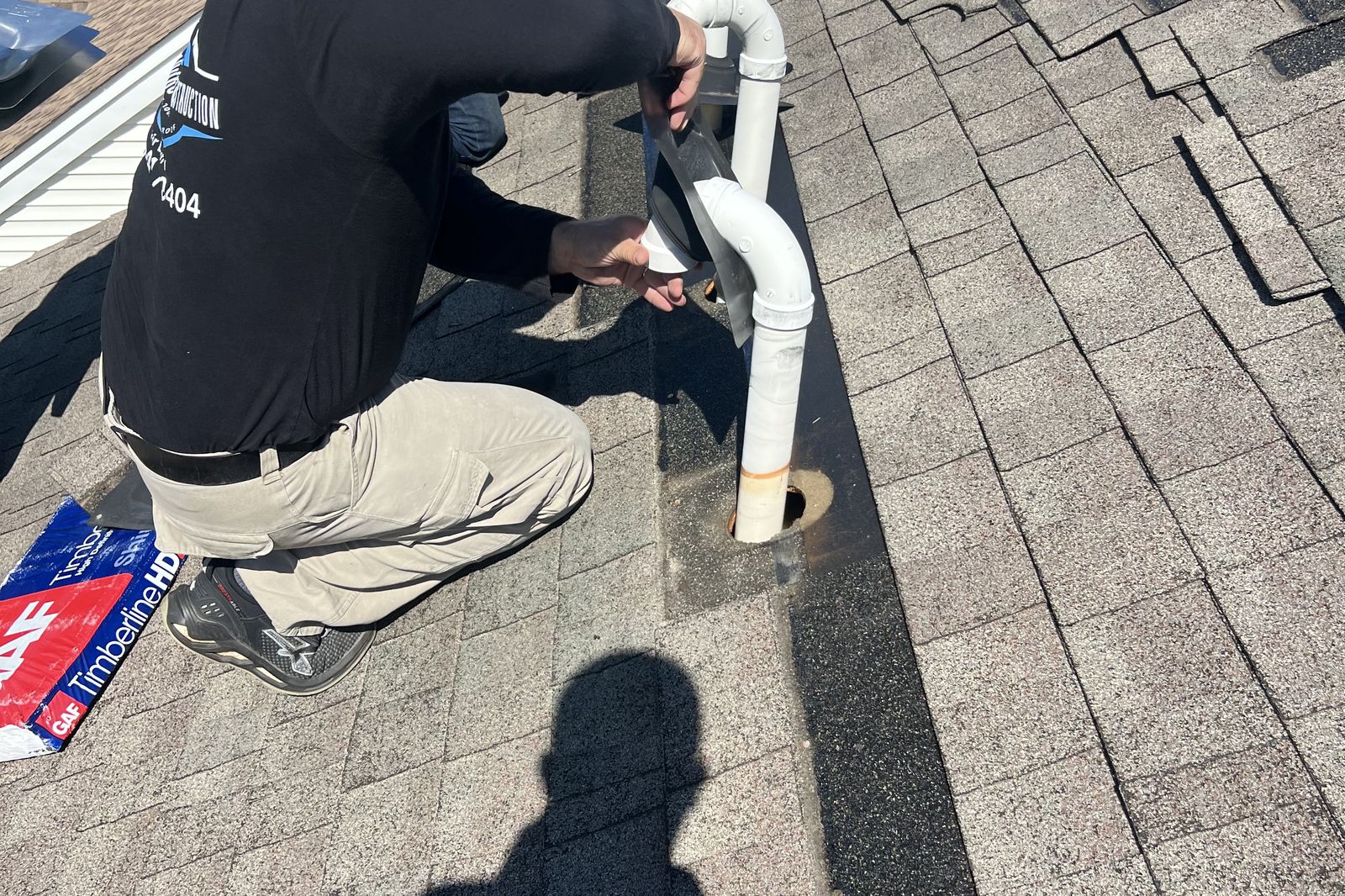 Ambassadors Construction roofer sealing vent pipe flashing during a roof repair in New Jersey