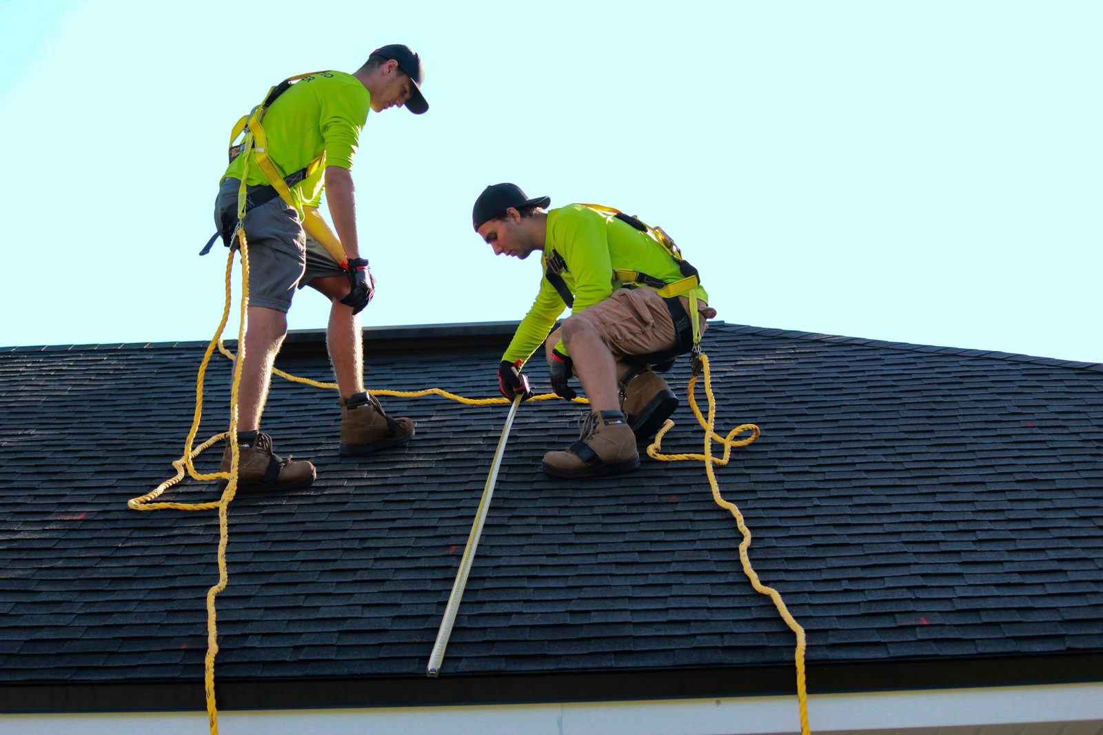 Ambassadors Construction roofing crew measuring shingles during a New Jersey roof installation