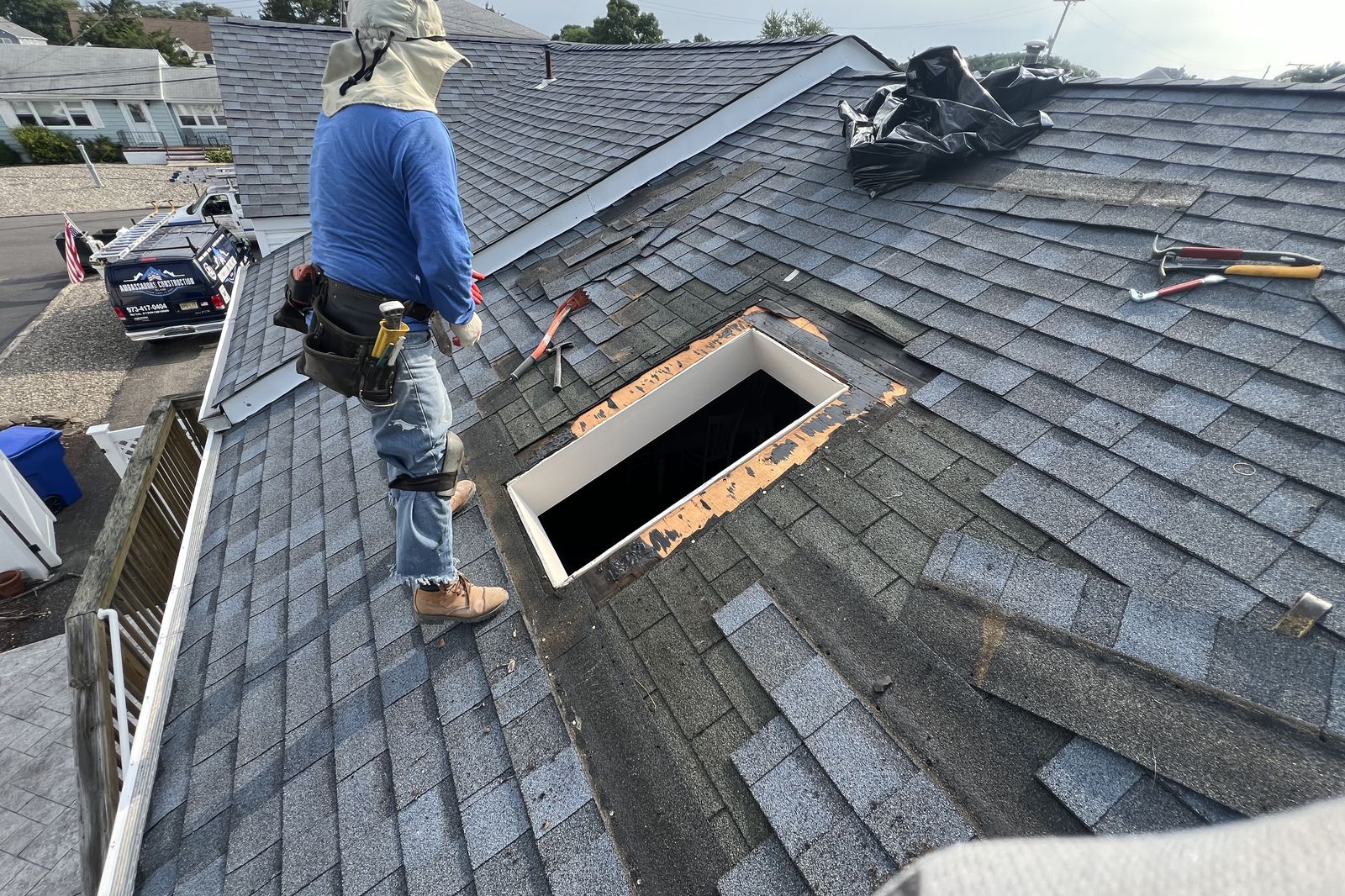 Ambassadors Construction roofer inspecting a skylight decking opening in New Jersey