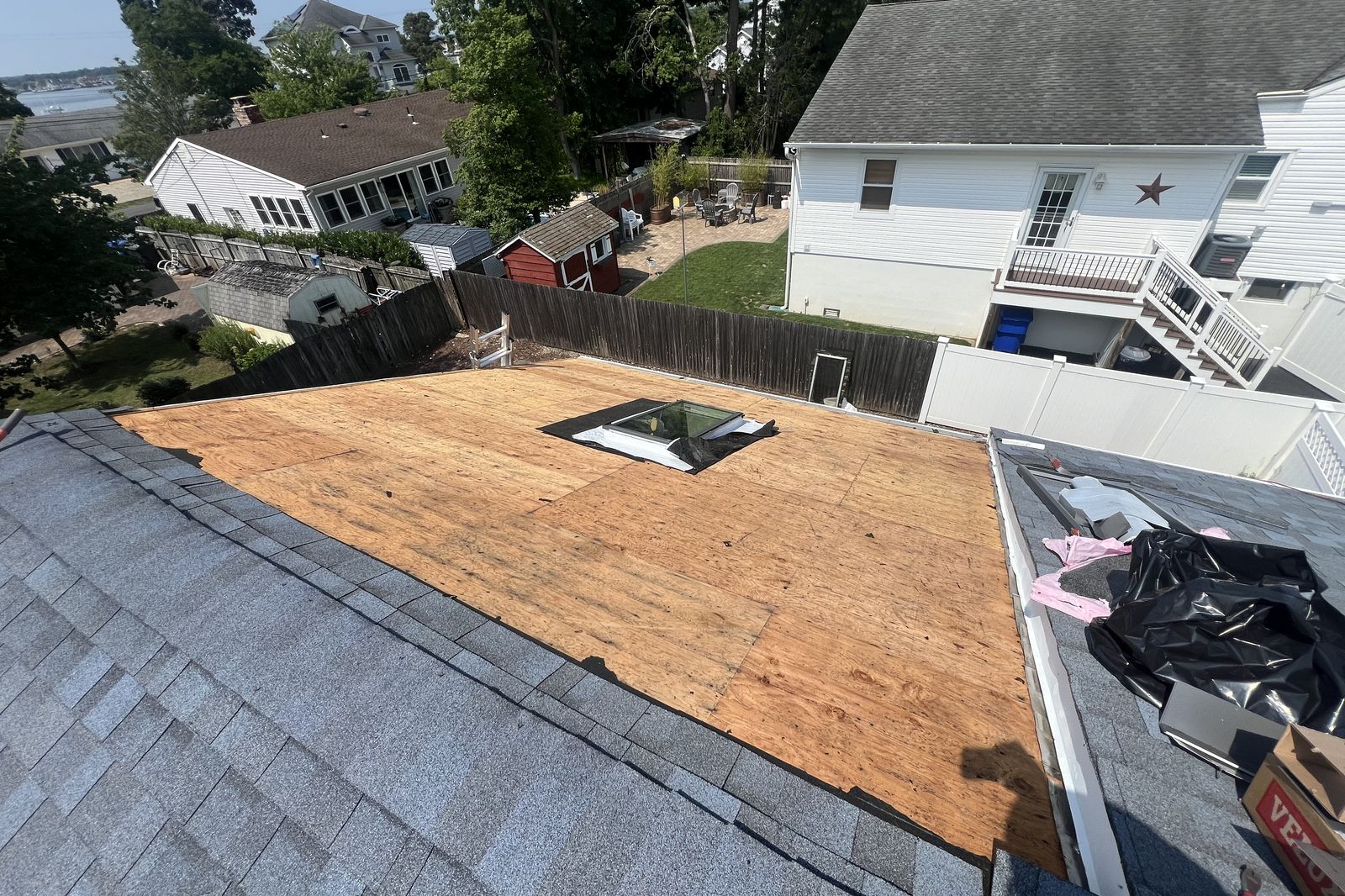New plywood decking installed around a new skylight during a New Jersey roof project