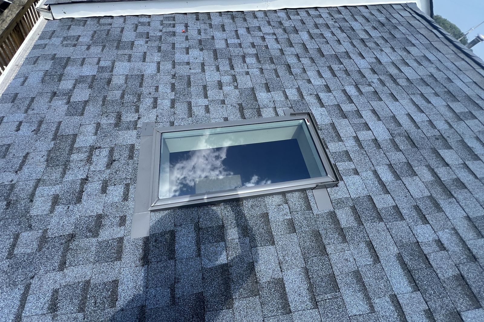Finished skylight with new shingles and flashing on a New Jersey roof